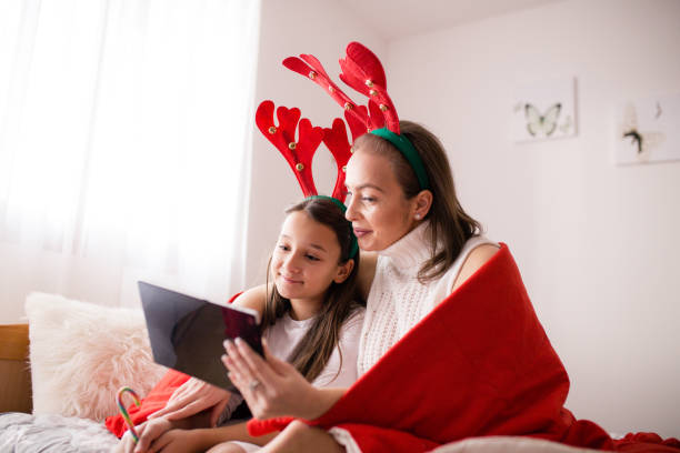 istock Mother and her daughter having Christmas video call 1357472052