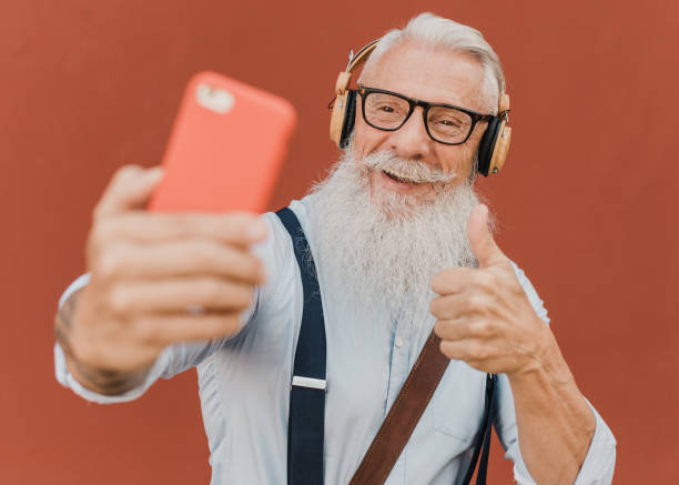 istock older man makes video call with his smartphone while indicating that it is all right 1357473804
