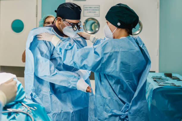 istock Medical workers preparing for surgery inside operation room at private hospital during coronavirus outbreak - Focus on male doctor face 1357477994