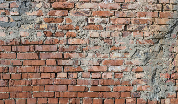 The facade of an old building. Texture of red brick wall background. stock photo