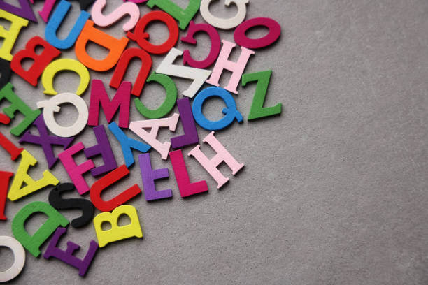 multi-colored magnetic letters of the Russian alphabet on a white board. letters are arranged in a random order. teaching literacy to children of preschool and school age