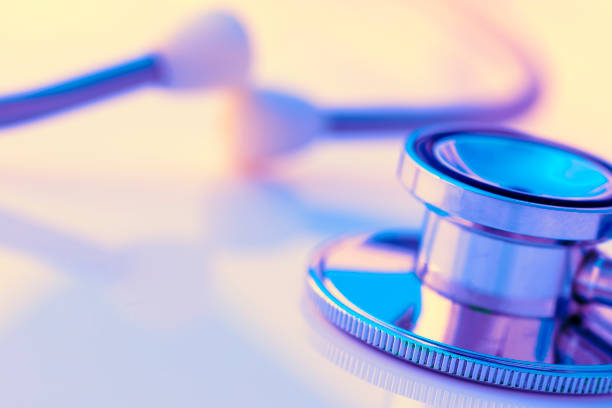Close-up of a stethoscope on a desk. Shallow depth of field, space for copy. Toned image.