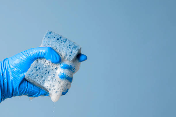 istock Hand holding a cleaning sponge with soap sud 1357486041