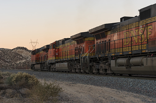Cajon Pass, California, USA - December 5, 2021: image of BNSF Railway locomotives shown traveling through the Cajon Pass.