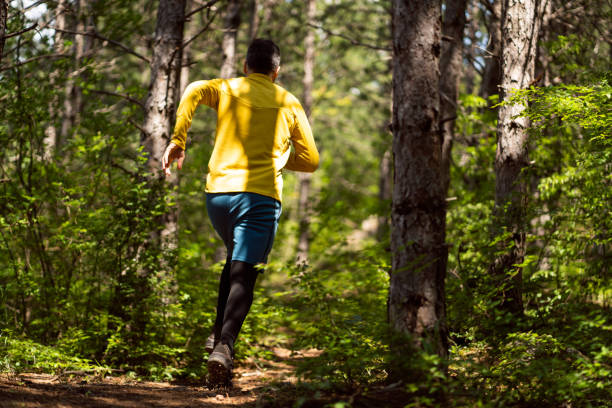 istock In the forest, during sunny day, unrecognizable healthy man running 1357491022