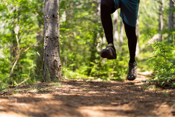 istock Unrecognizable man jogging in the forest 1357491031