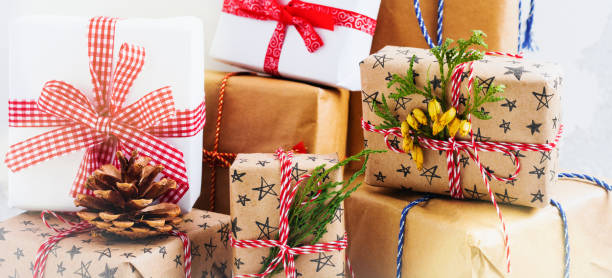 istock Colorful wrapped gift boxes with presents on white textured background. Selective focus.Place for text. 1357491115