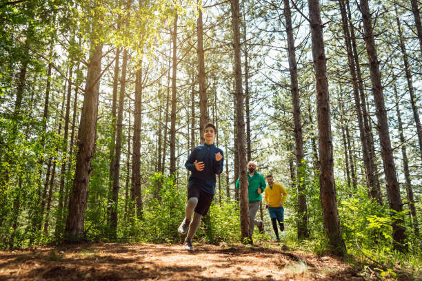 istock Teeange boy running through forest with his family 1357491131