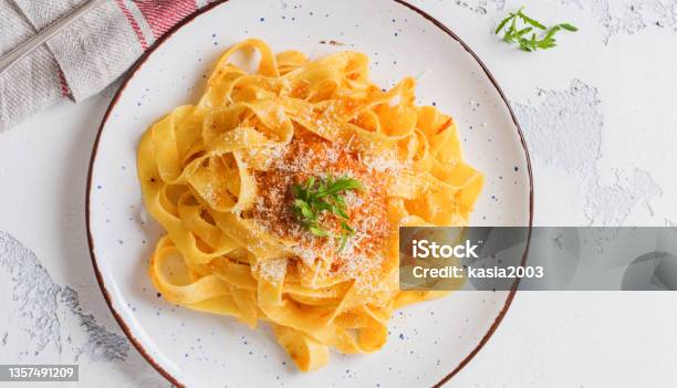 Fettuccine Pasta With Traditional Italian Passat Sauce And Parmesan Cheese In Light Plate On Old White Concrete Background Top View Stock Photo - Download Image Now