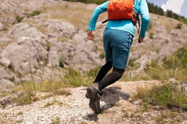 istock Unrecognizable active man, running up the rocky mountain 1357491228