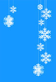 istock Hanging white paper snowflakes on blue background. 1357491756