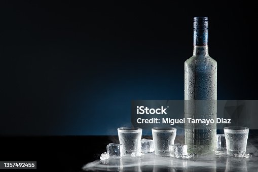 https://media.istockphoto.com/id/1357492455/photo/ice-cold-bottle-of-vodka-with-shot-glasses-on-dark-blue-background-with-copy-space.jpg?s=170667a&w=is&k=20&c=NdEBEcnBgnNhD9N1e54Dir6Fp8_4u7ygGdIsbQIP0X4=