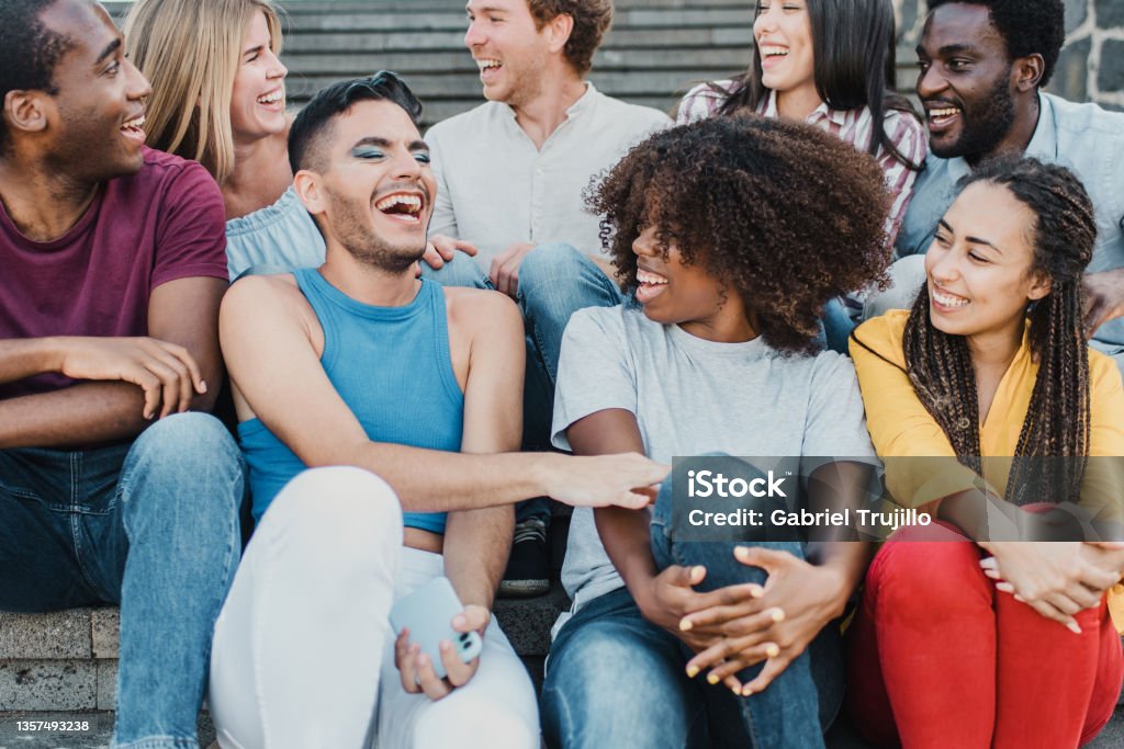 Multiracial people having fun outdoor in the city - Focus on center girl face Multiracial people having fun outdoor in the city - Focus on center girl face. Community Stock Photo