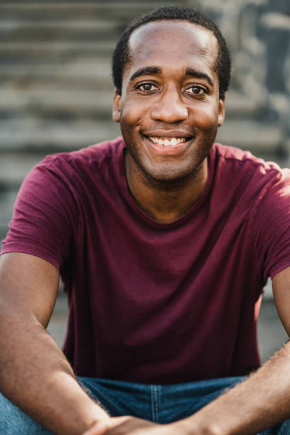 istock Cheerful black man looking at camera on street 1357493397