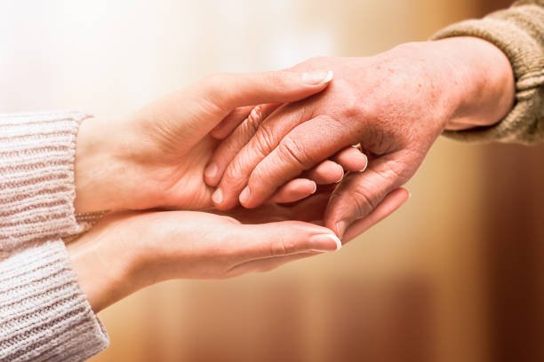 istock young hand holds hand of senior 1357496317