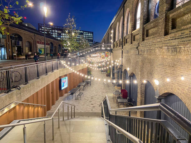 Coal Drops Yard shopping complex in King's Cross, London, UK London, UK - November 22 2021: Exterior side view of the Coal Drops Yard shopping complex in King's Cross at night. camden market stock pictures, royalty-free photos & images