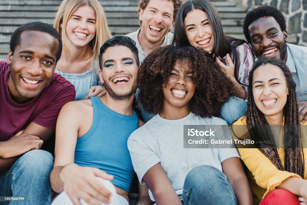 Young group of people smiling on camera having fun outdoor in the city - Focus on african girl face Young group of people smiling on camera having fun outdoor in the city - Focus on african girl face. Multiracial Group Stock Photo