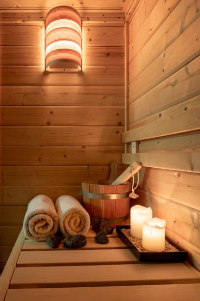 Interior of a small Finnish wooden sauna with sauna accessories Interior of a small Finnish wooden sauna with sauna accessories. sauna stock pictures, royalty-free photos & images