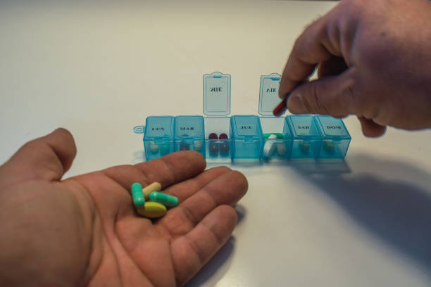 istock Senior man organizing his medication in pill dispenser 1357502016