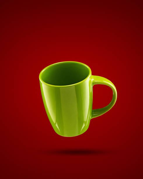 istock Green mug on red background with vignette 1357505729