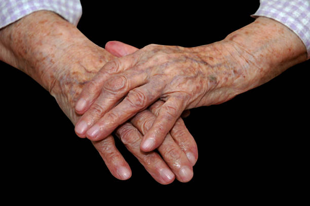 Hands of a 103 years old lady Hands of a 103 years old lady on a black background over 100 stock pictures, royalty-free photos & images
