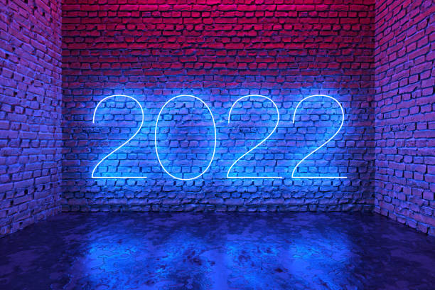 Blue gradient text 2022 on brick wall background stock photo