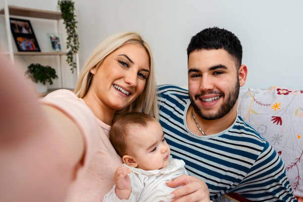 istock Young romantic couple taking a selfie with their child 1357511232