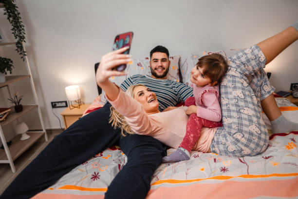 istock Young romantic couple taking a selfie with their child 1357511247