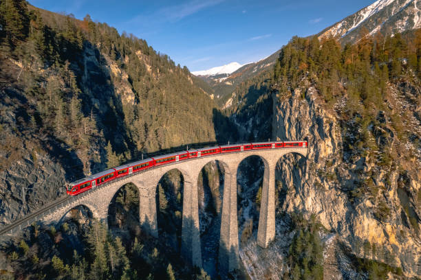 Train in Switzerland Crossing the Landwasser Viaduct A train passing along the famous Landwasser railway, famous for the viaduct and beautiful scenery surrounding the railway in the Switzerland mountains graubunden canton photos stock pictures, royalty-free photos & images