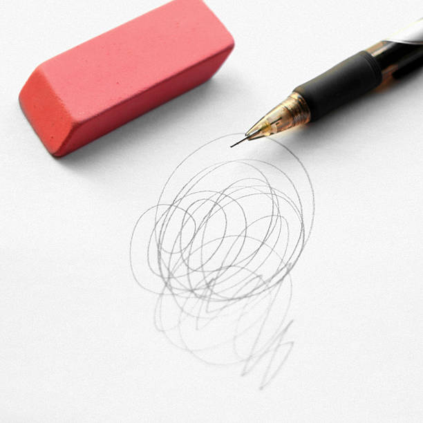 Close up white eraser and black pencil on blank notebbok