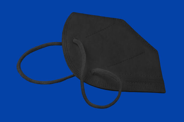 istock Black Corona FFP2  Face Mask on blue background 1357512653