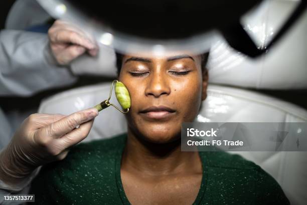 Young woman receiving a facial massage at a spa