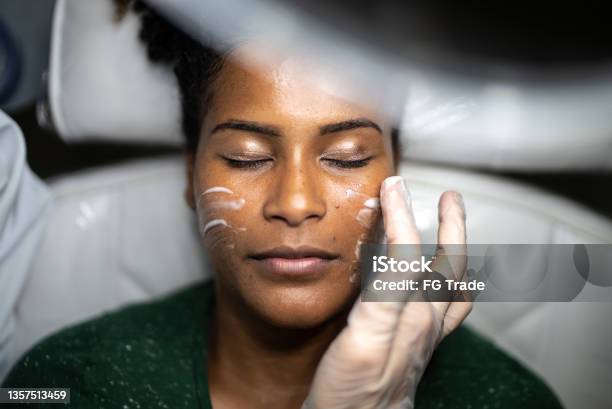 Young Woman Doing A Facial Treatment At A Spa Stock Photo - Download Image Now - Aesthetician, Beautician, Black People