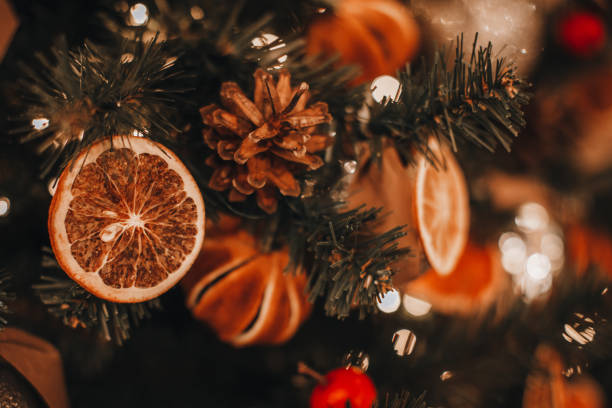 istock Creative interesting Christmas tree decorated with dry oranges, pine cones. 1357516614