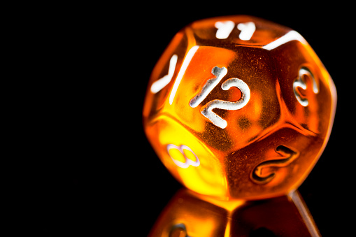 Orange twelve sided dice used in role playing games.