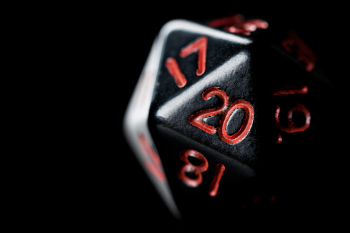 Black twenty sided dice used in role playing games.