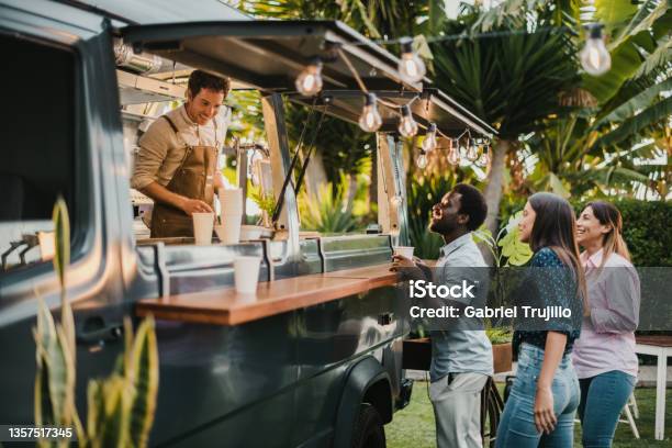 Multiracial Friends Making Order To Seller In Food Truck Stock Photo - Download Image Now