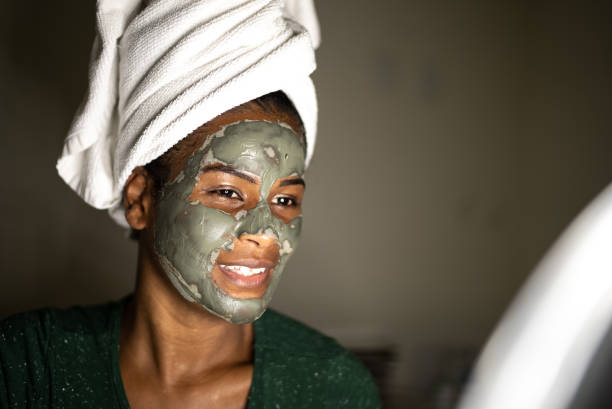 istock Young woman using a facial mask 1357517488