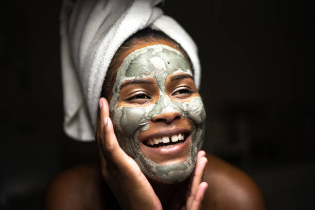 istock Young woman using a facial mask 1357518257