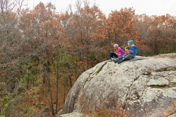 istock Children on Large Granite Rock in Autumn Woods 1357519639