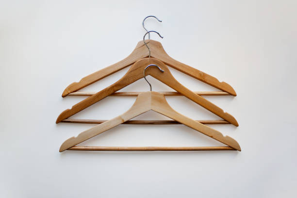 istock Three wooden hangers on white background from above 1357519705