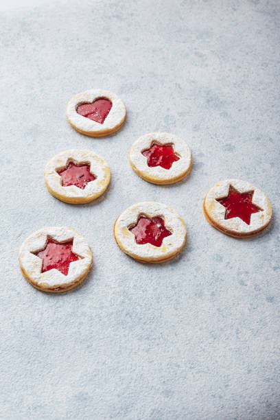 istock Classic Linzer Christmas Cookies with raspberry or strawberry jam on light background. 1357520306
