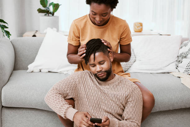 istock Shot of a young couple using a phone at home 1357520409