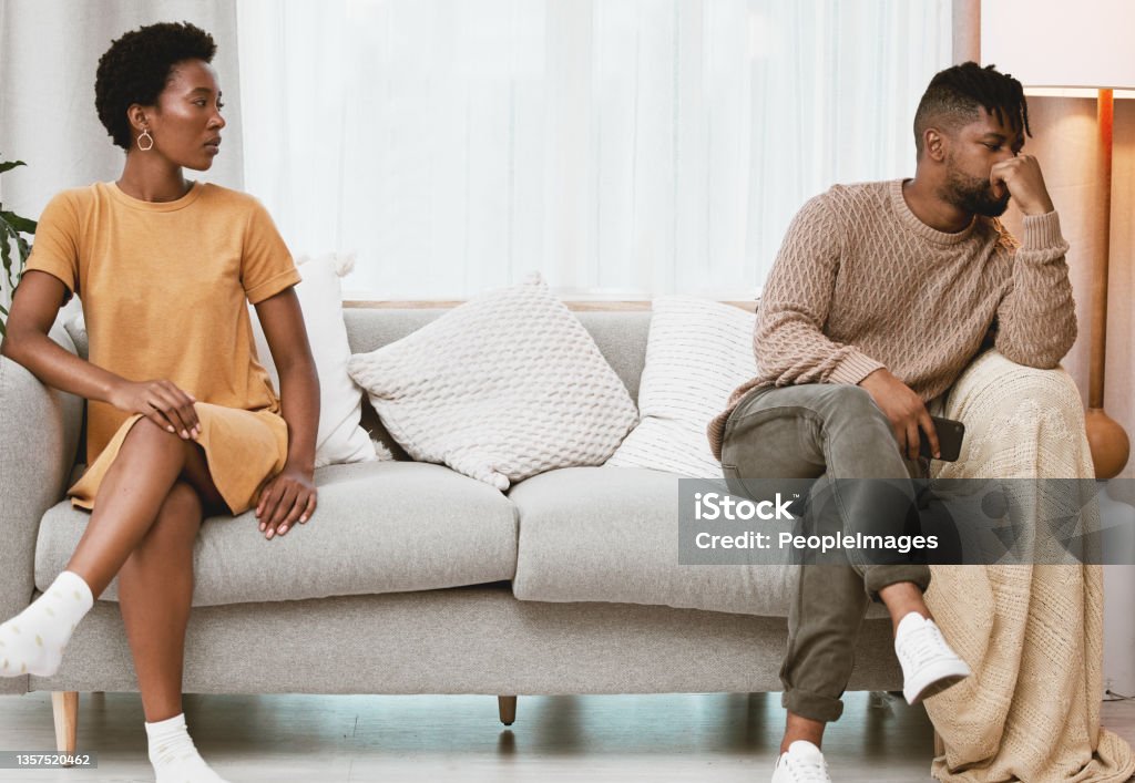 Shot of a young couple having an argument at home When am I getting your attention? Arguing Stock Photo