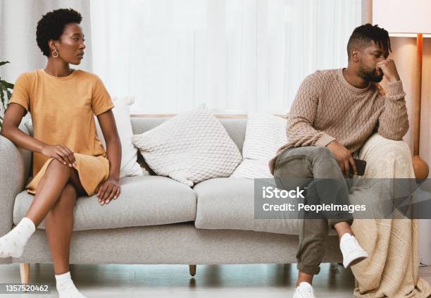 Shot Of A Young Couple Having An Argument At Home Stock Photo - Download Image Now - Arguing, Boyfriend, Girlfriend