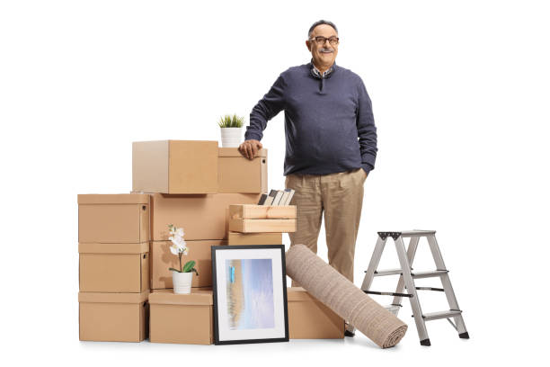 istock Mature man standing next to cardboard boxes packed for removal 1357522103