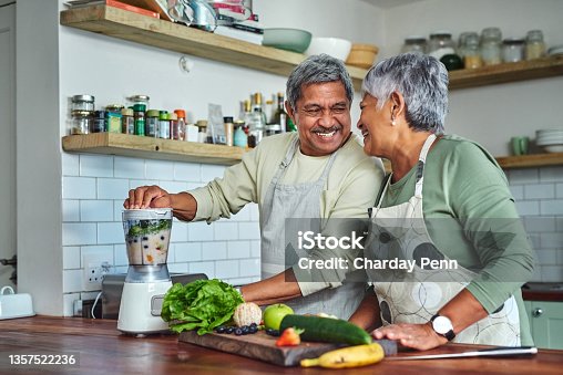 istock Shot of a senior couple preparing a healthy smoothie in the kitchen at home 1357522236