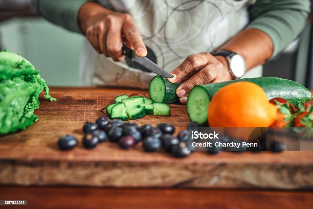 Shot of an unrecognisable senior man cooking a healthy meal at home All the colours of the vitamin rainbow Healthy Eating Stock Photo
