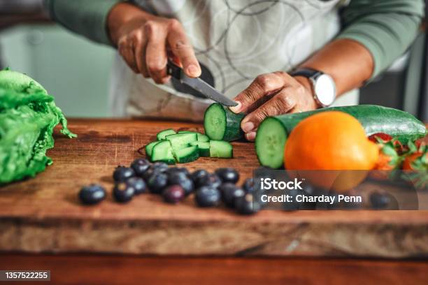 Shot Of An Unrecognisable Senior Man Cooking A Healthy Meal At Home Stock Photo - Download Image Now
