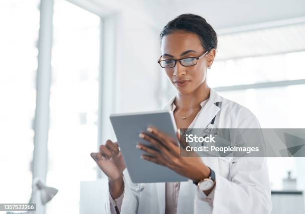Shot Of A Young Doctor Using Her Digital Tablet At Work Stock Photo - Download Image Now